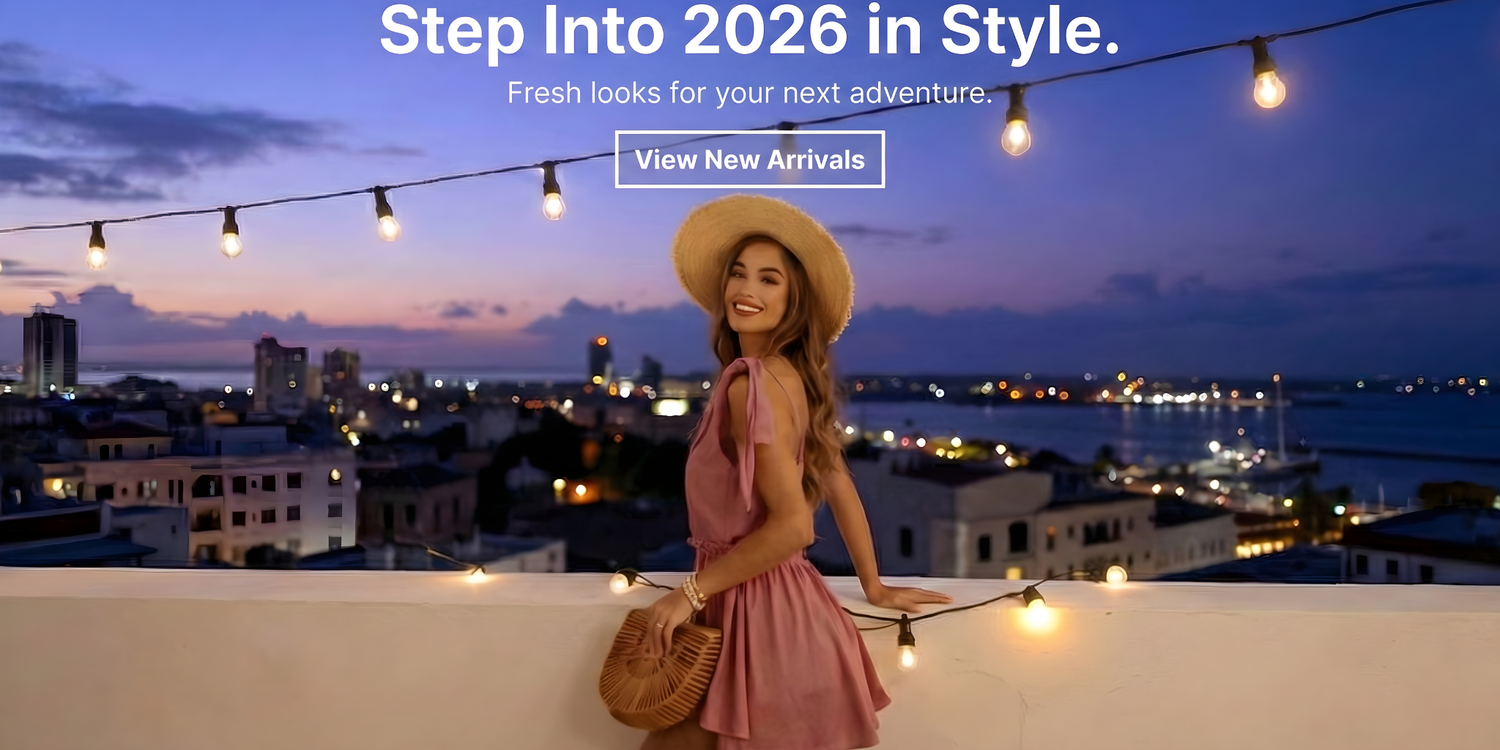 Step Into 2026 In Style - Fresh looks for your next adventure - View New Arrivals - Meet Angela's V-Neck Tie Shoulder Mini Dress — effortless fit, flirty length, and tie-shoulder details that actually make getting dressed fun. Throw on sneakers for daytime energy or sandals for a night out. Lightweight, easy to pack, and low-key chic — perfect for quick plans or spontaneous dates. Grab it for $32 and elevate your Woma in a pink dress and straw hat standing on a rooftop with cityscape and ocean view at dusk.